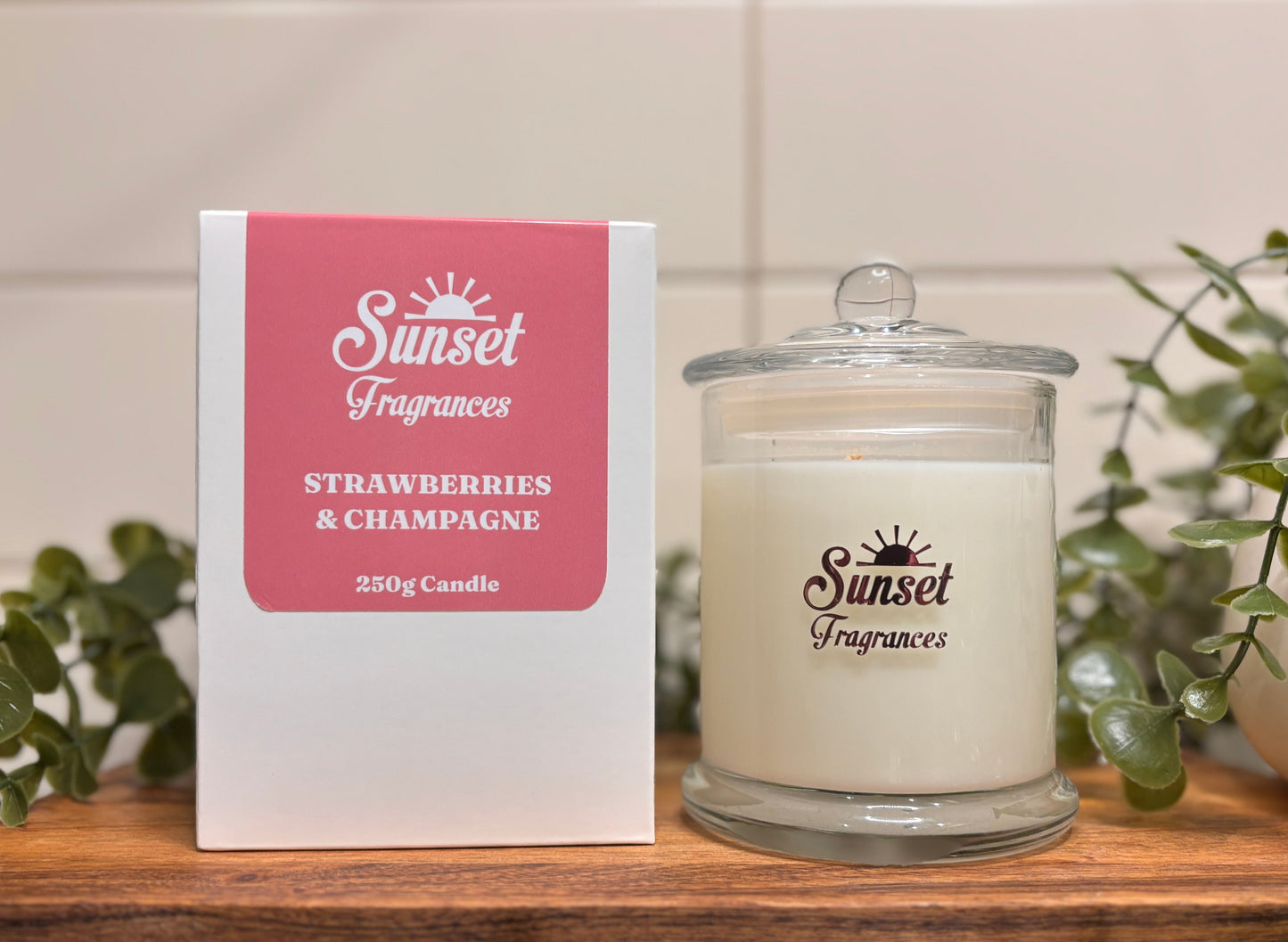 Scented candle sitting beside a labelled box